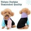Two fluffy dog portraits wearing unique purple and light blue hoodies