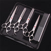 A professional stainless steel pet grooming scissors set with various blades and a comb displayed in a black case.