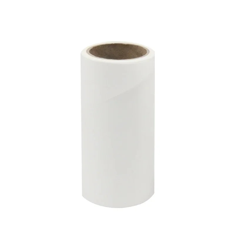 A white adhesive lint roller with a cardboard core.