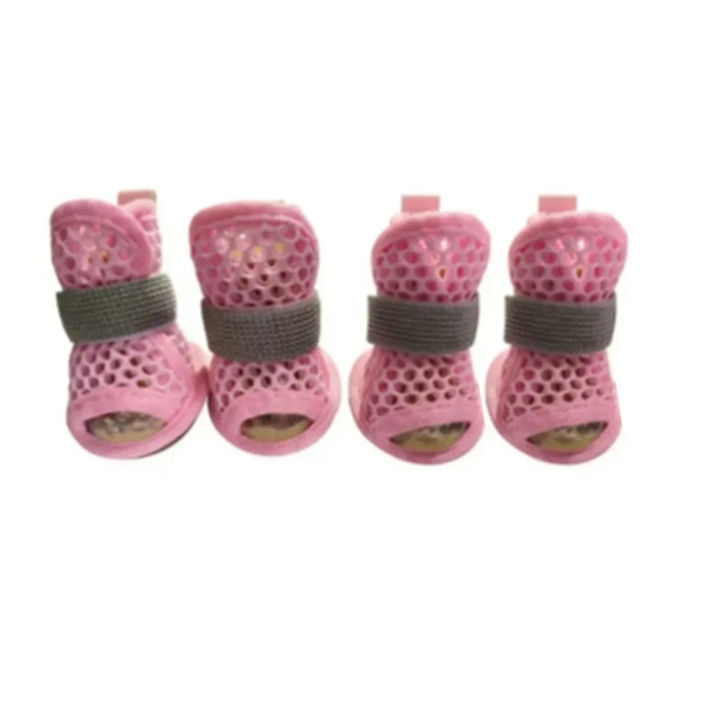 A pack of four pink breathable mesh dog shoes for summer protection.