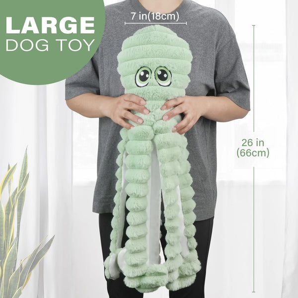 A person holds a large, light green, squishy octopus grinding teeth squeaky pet toy.