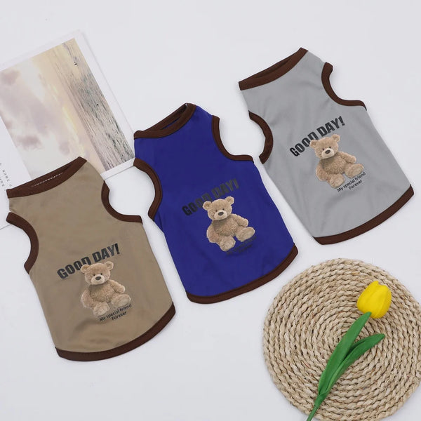 Three pet vests in brown, blue, and gray featuring a cartoon bear design.
