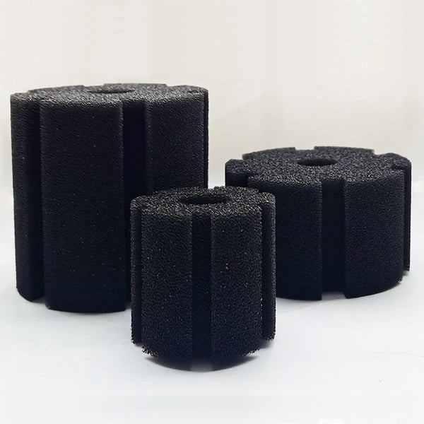 Three black biological aquarium sponge filters standing upright on a white surface.