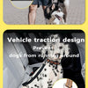 A dog wearing a reflective bungee leash with a car seatbelt clip sits in the back seat of a vehicle.