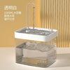 A clear glass water fountain with a white filter housing and a decorative water spout, filled with water and ice.