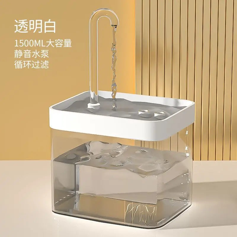 A clear glass water fountain with a white filter housing and a decorative water spout, filled with water and ice.