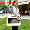 A woman holds a beige pet bag backpack featuring a cat silhouette and the words Fashion Pet Bag.