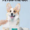 A happy Shiba Inu dog is looking at the camera next to a box of pet wipes.