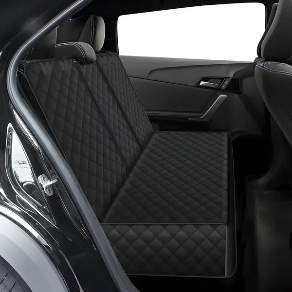 Black quilted waterproof dog car seat cover installed in a vehicle's back seat.