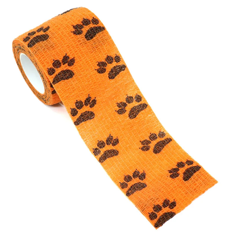 Orange pet leggings with brown paw prints for walking dogs