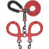 A dual dog leash with shock absorbing bungee for two dogs, featuring red and black cord handles.