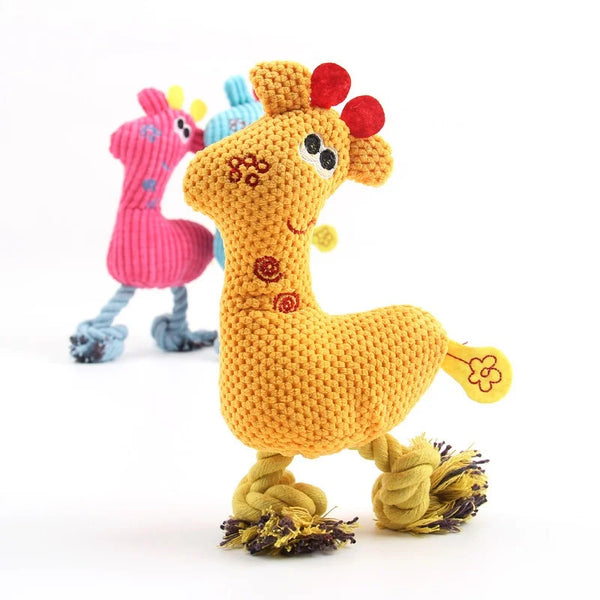 A yellow knitted plush toy shaped like a giraffe with pink and blue accents, used as an interactive squeaky chew toy.