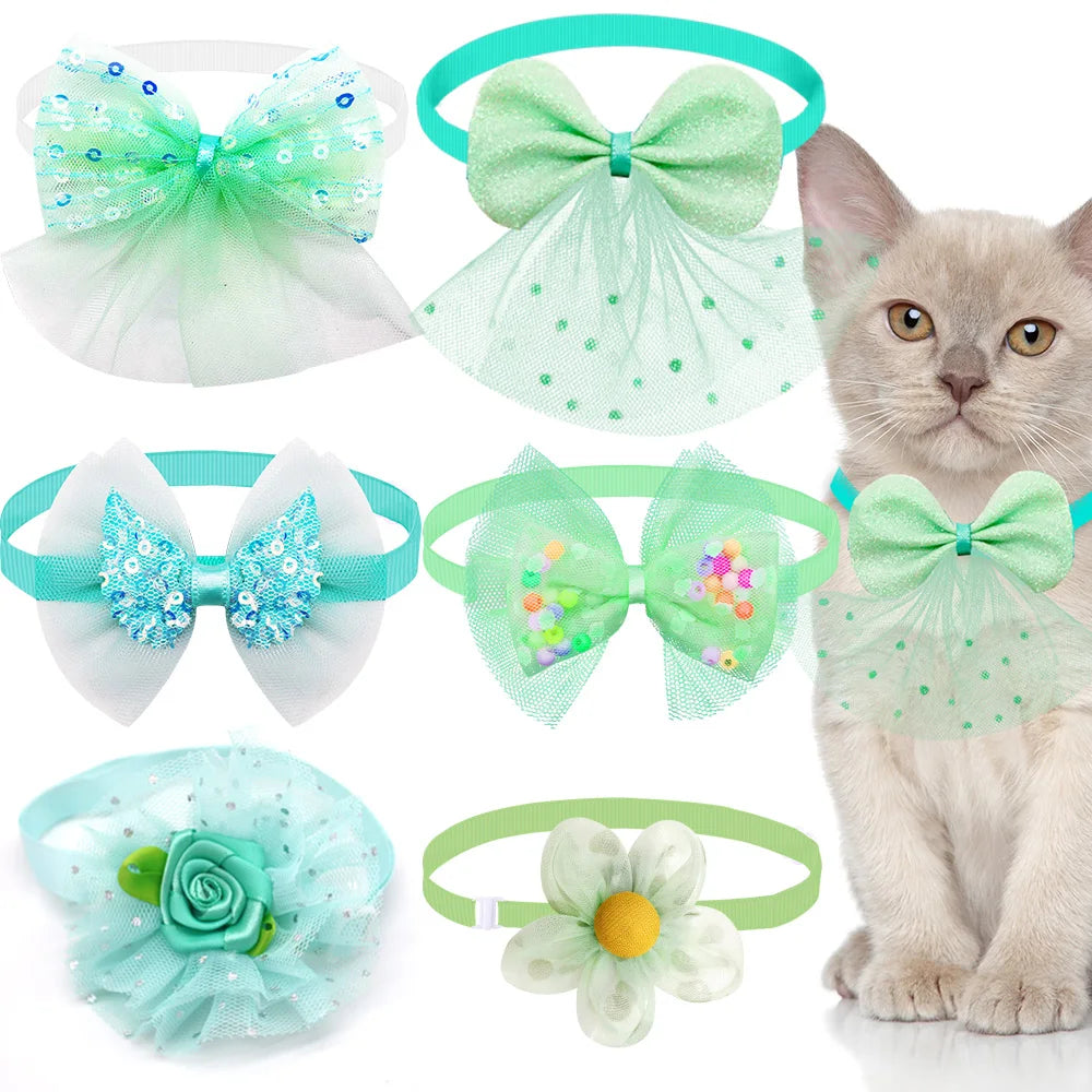 A collection of lace bow tie collar accessories for small dogs and cats in various shades of green and blue.
