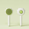 A white pet hair removal slicker brush with a green textured head and a smooth body.