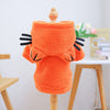 An orange flannel hoodie designed for small dogs, displayed on a wooden stand.