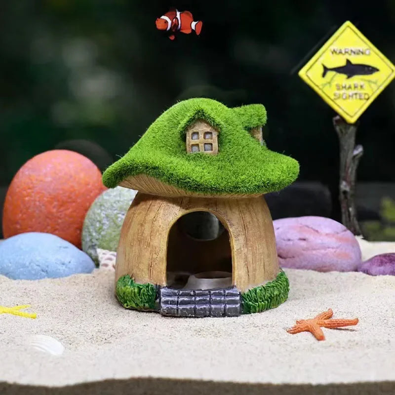 A miniature resin aquarium house decor shaped like a green tree, featuring a wooden hiding shelter and a warning sign.