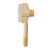 A beige pet hair remover brush with a wide comb attachment.