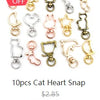 A set of ten antique silver cat heart snap charms for jewelry making.
