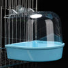 A clear plastic hanging bird bath for parakeets is suspended in a wire cage.