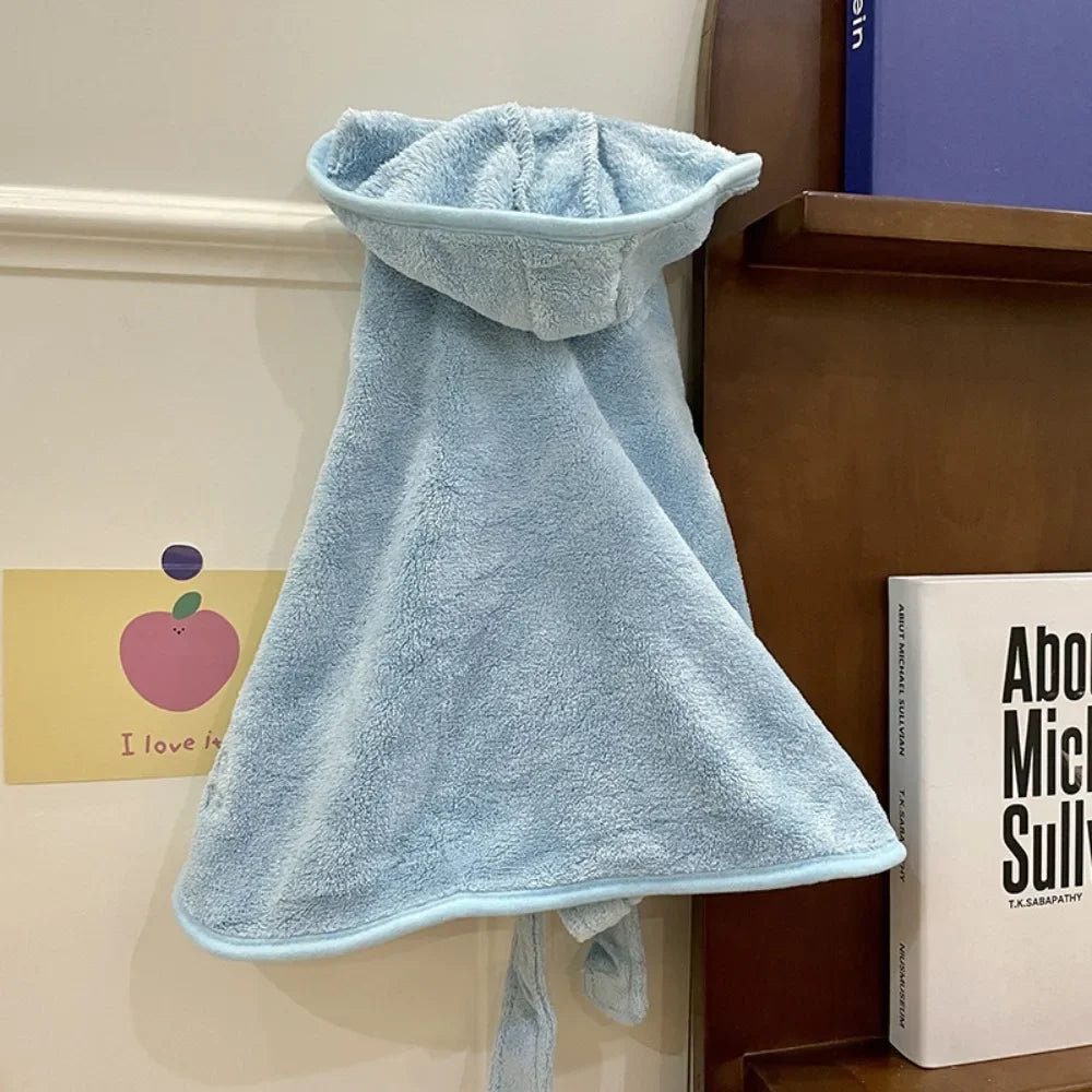 A light blue multi-purpose pet bath robe for dogs hanging on a shelf.