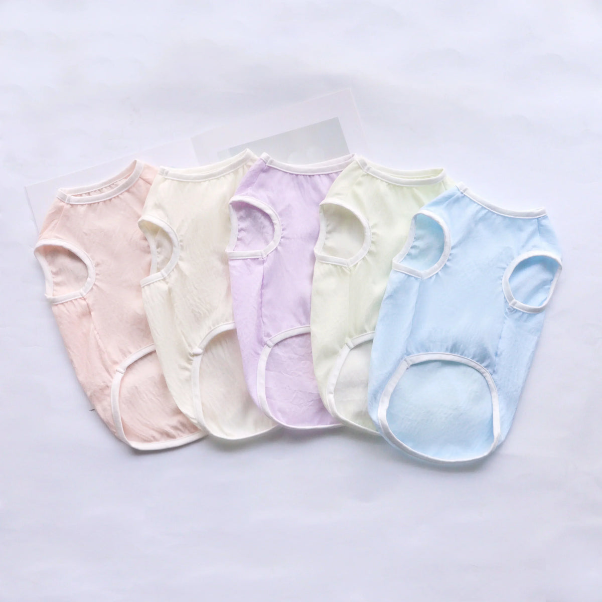 A set of five pastel-colored breathable summer pet vests for dogs and cats displayed on a white background.