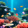 Colorful resin turtle ornaments swimming in a vibrant underwater reef scene.