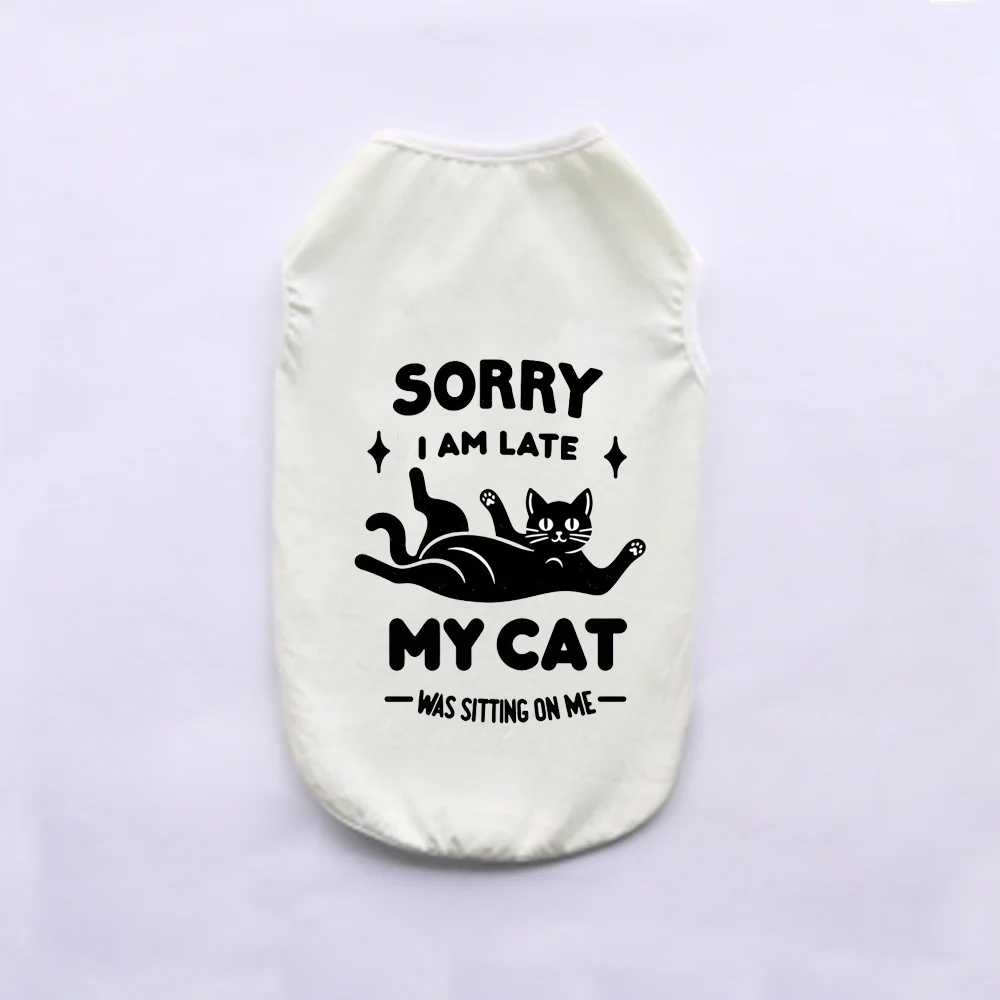 A cream-colored pet vest with black text that reads Sorry I am late My cat was sitting on me.