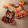 An orange pumpkin lace dress for a small dog, featuring orange fabric and black trim.
