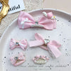 Pink bow hair accessory for children featuring rhinestone and pearl accents