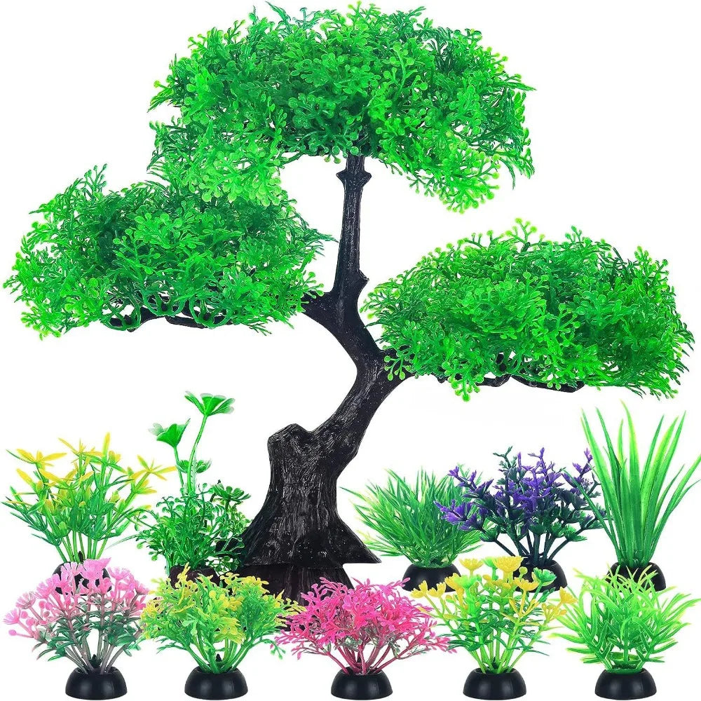 Colección de plantas acuáticas artificiales realistas en tonos verdes y rosas sobre un tronco de árbol oscuro.