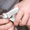 A hand is using a white professional LED pet nail clipper to trim a cat's nail.