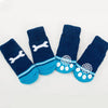 A pack of four navy blue and turquoise knit dog socks featuring a white tiger design.