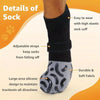 A close-up of a black anti-slip dog sock with an elastic cuff and silicone grip design.