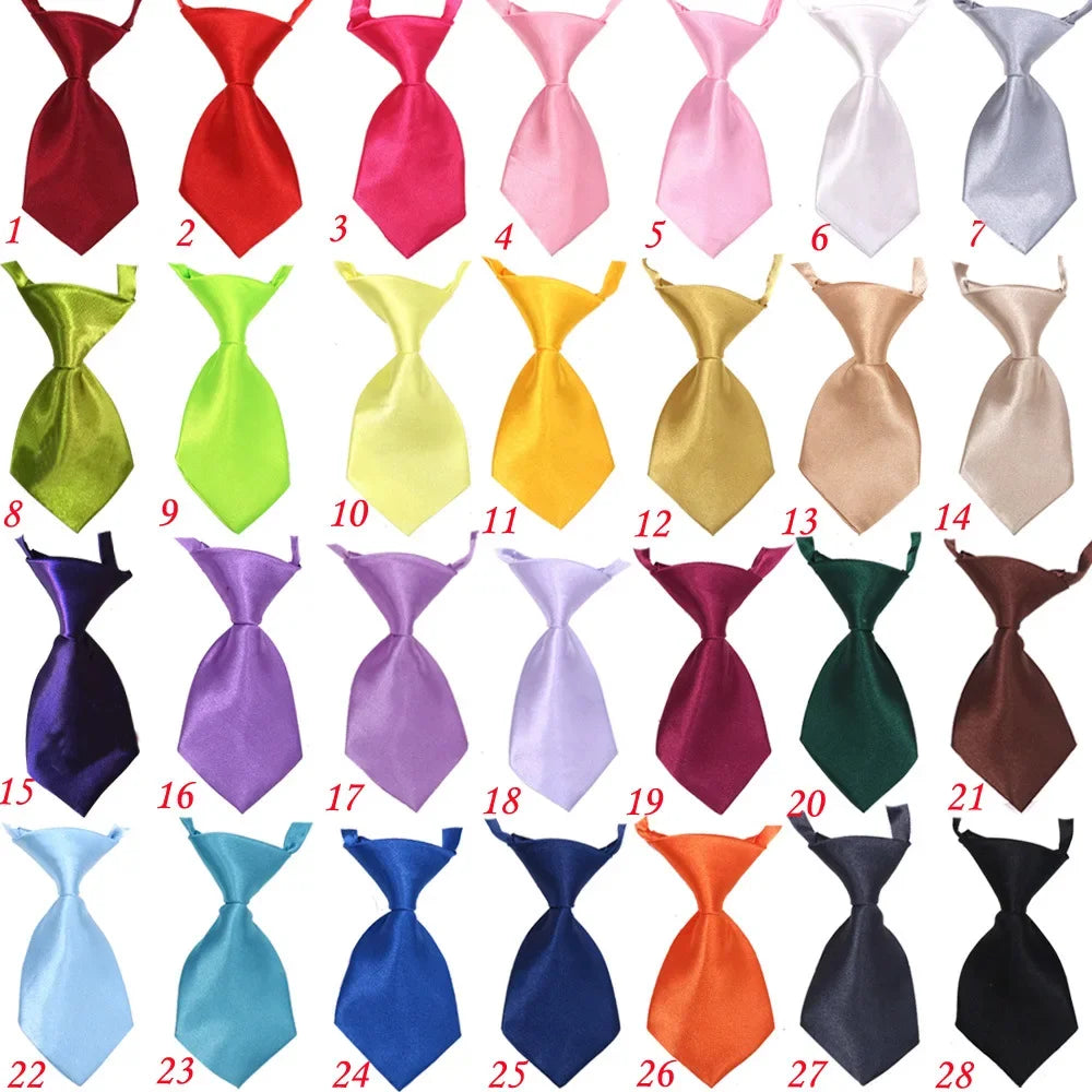 A collection of 28 adjustable pet bow ties in various colors and patterns for dogs and cats