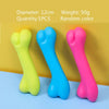 Three rubber chew toys shaped like dog bones in yellow, blue, and pink colors