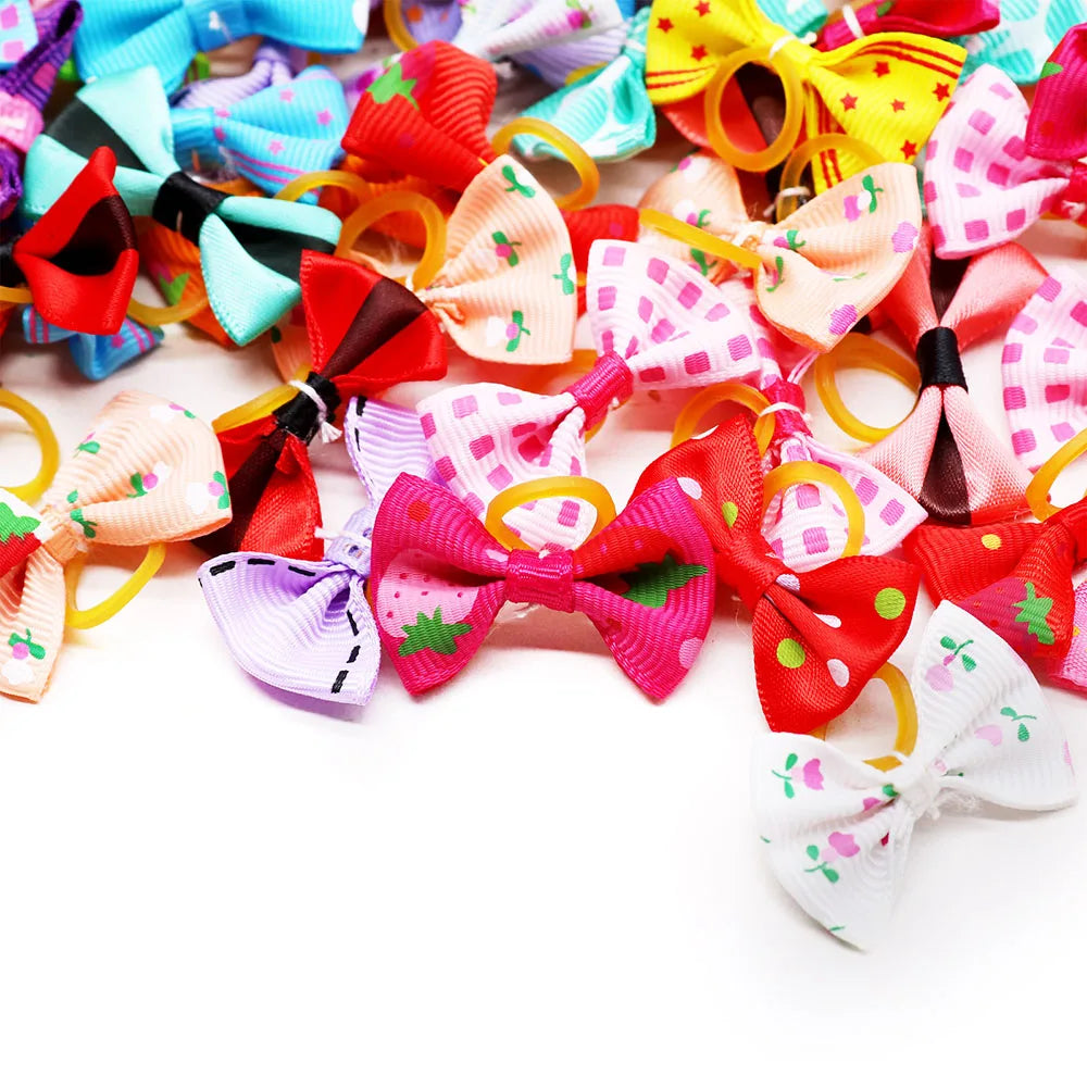 A colorful assortment of 30 handmade dog bows for hair accessories in various pink, red, yellow, and purple patterns.