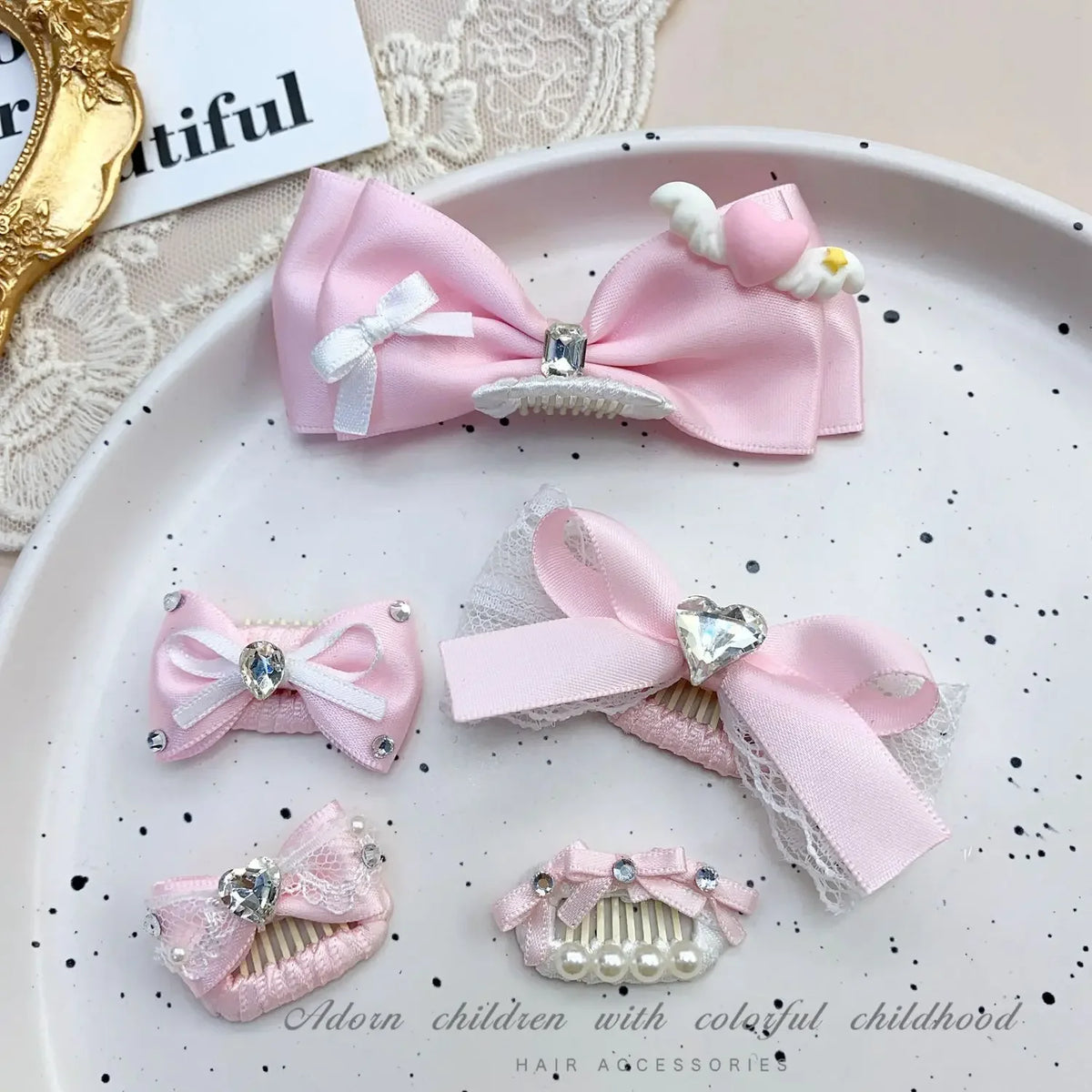 Pink bow pet hair clip with rhinestone and pearl accents displayed on a white plate.