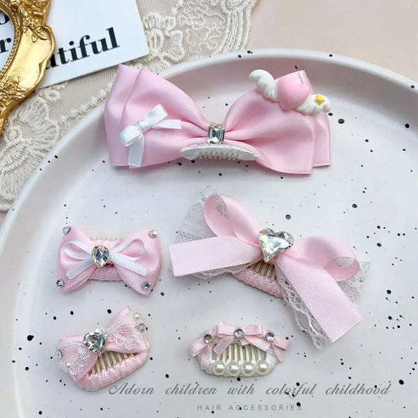 Pink bow pet hair clip with rhinestone and pearl accents displayed on a white plate.