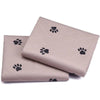 A stack of beige washable reusable dog urine pads featuring a subtle paw print pattern.