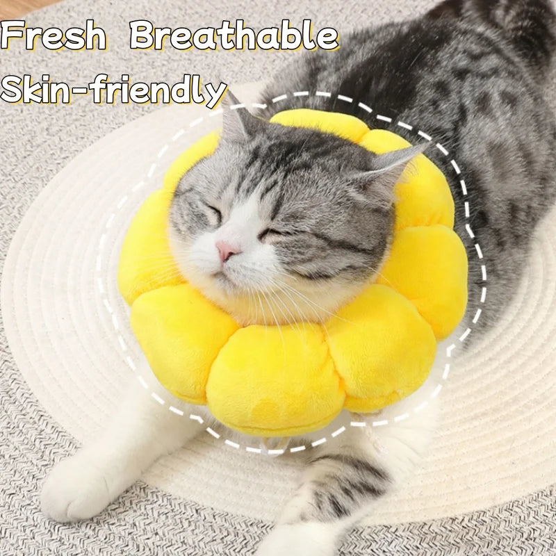 A gray cat is resting its head inside a yellow soft plush Elizabethan collar for pet wound care.