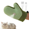 A light green electric pet grooming brush with a steam comb attachment being used on a cat.