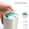 A hand is shown using a white plastic container with an integrated tool to remove cat litter and isolate odor.