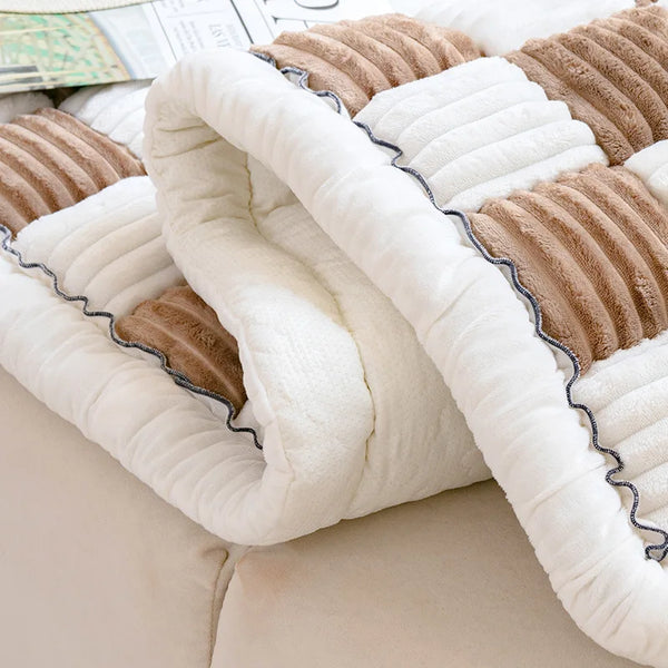 A plush fleece pet bed and mat featuring white and brown textured fabric.
