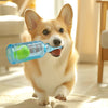 A happy Shiba Inu dog is running and carrying a blue squeeze bottle filled with a green tennis ball toy.
