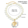 Gold-toned pearl choker necklace featuring a heart pendant and a beaded chain.