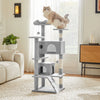 A gray cat tree tower with multiple tiers and sisal scratching posts stands next to a window.