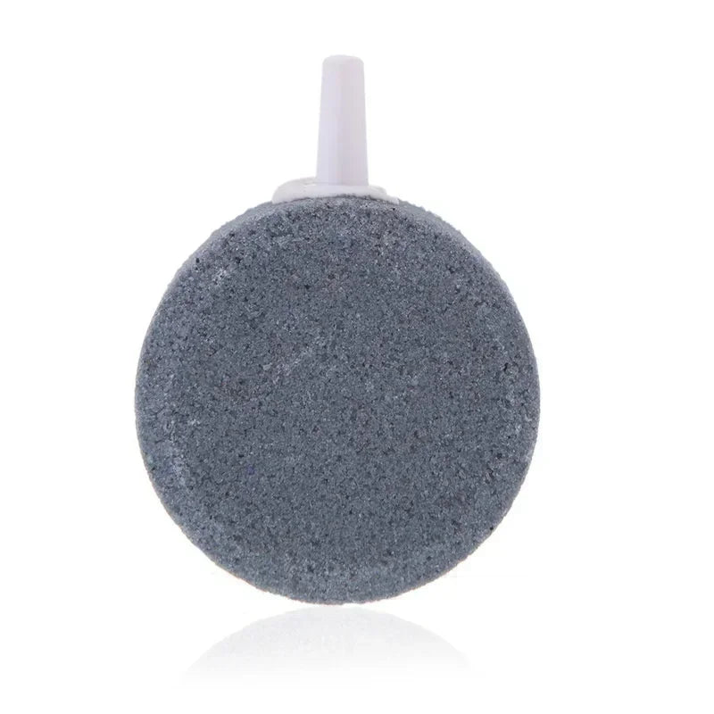 A grey air stone disc with a white nozzle for aquarium oxygenation.