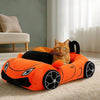 An orange supercar shaped cat bed with a plush cushion and black accents, featuring an orange tabby cat.
