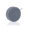 A grey air stone disc used for aquarium oxygenation.