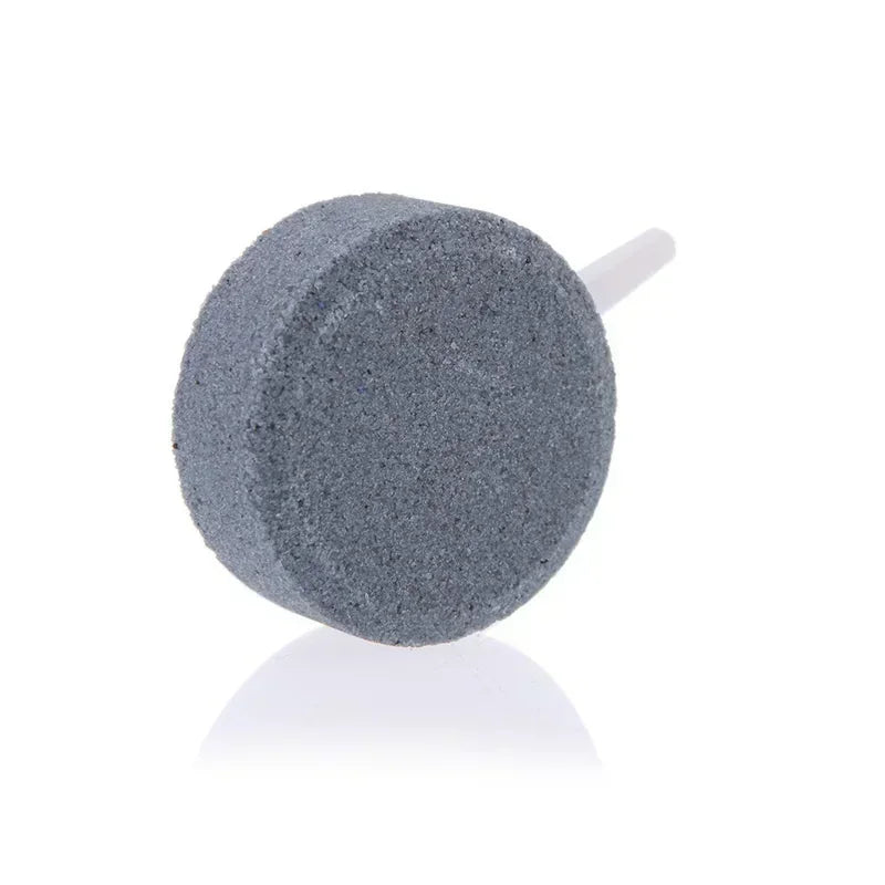 A grey air stone disc used for aquarium oxygenation.